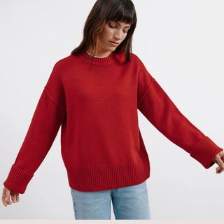 Flat lay image of woman wearing red jumper