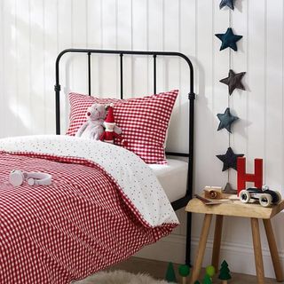 Red gingham bedding in a child's white bedroom