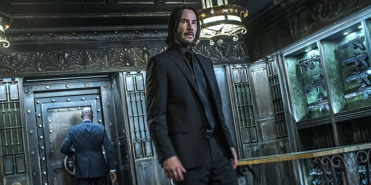 Black suited Keanu Reeves in Continental hotel in John Wick 3