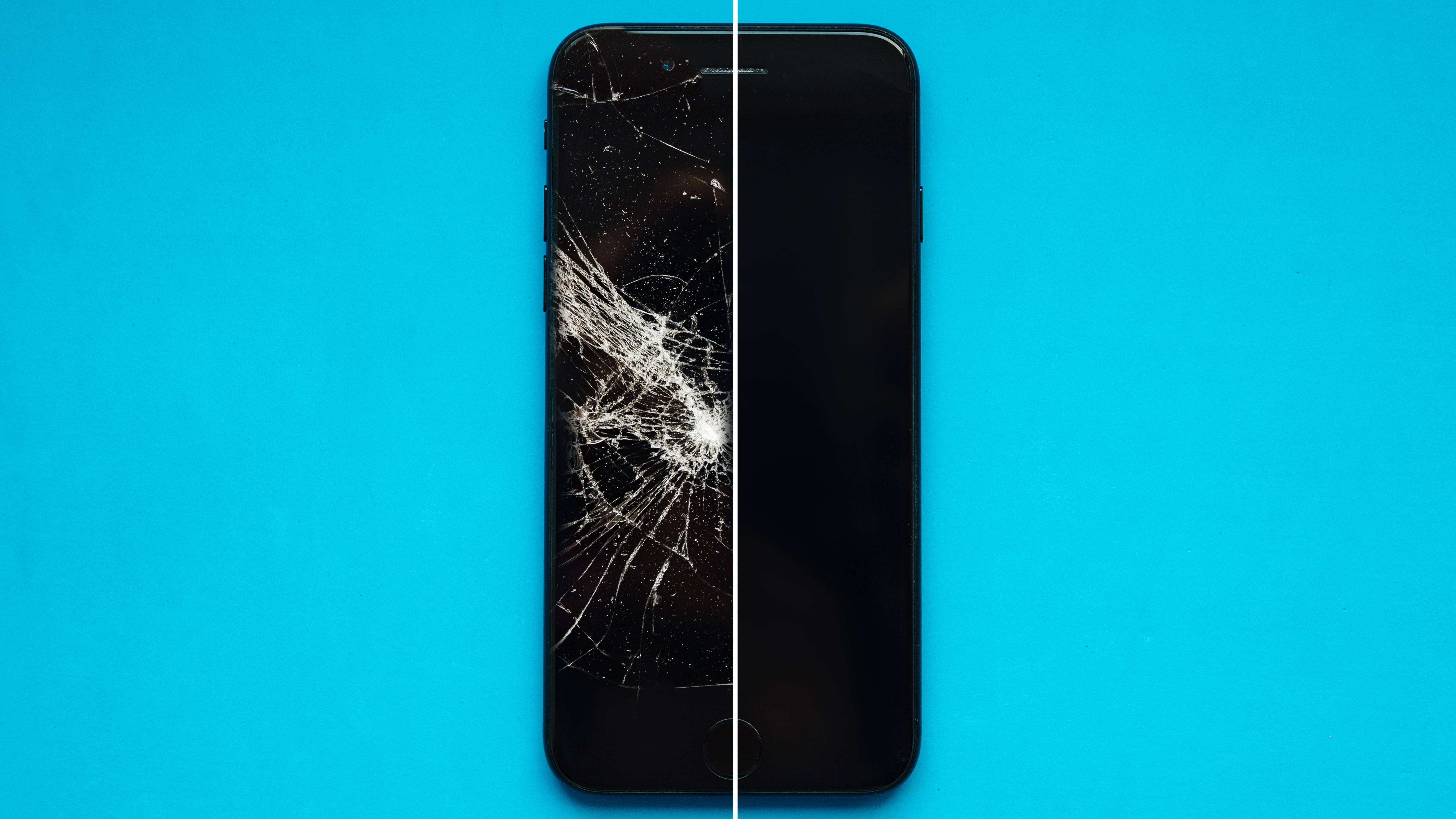 A broken iPhone on a blue background