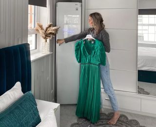 woman opening closet with long green dress