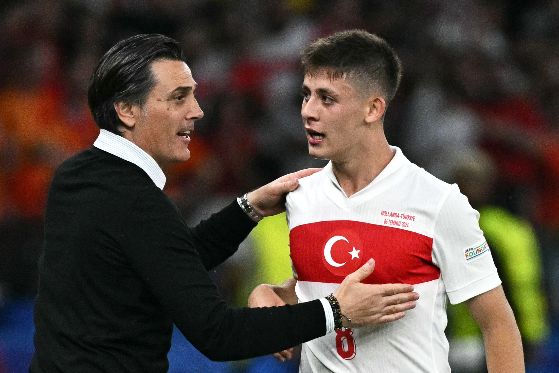 Turkey coach Vincenzo Montella speaks to Arda Guler during a match against the Netherlands at Euro 2024.