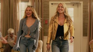 L to R Michelle Randolph as Ainsley Norris and Ali Larter as Angela Norris smiling and walking.