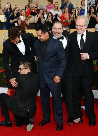 Actors Bradley Cooper, Michael Pena, and Mandy Patinkin and playwright and actor Tracy Letts arrive at the 20th Annual Screen Actors Guild Awards as Ukrainian reporter and prankster Vitalii Sediuk grabs Cooper's legs