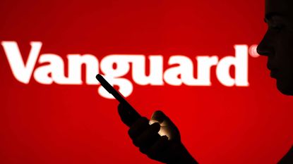 Vanguard logo on red screen with person looking at smartphone