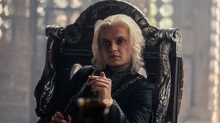 Aegon II (Tom Glynn-Carney) sitting in a chair in the Small Council room in "House of the Dragon" season 2