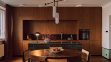 chic modern kitchen with wooden cabinetry and splashback and a green tiled kitchen island