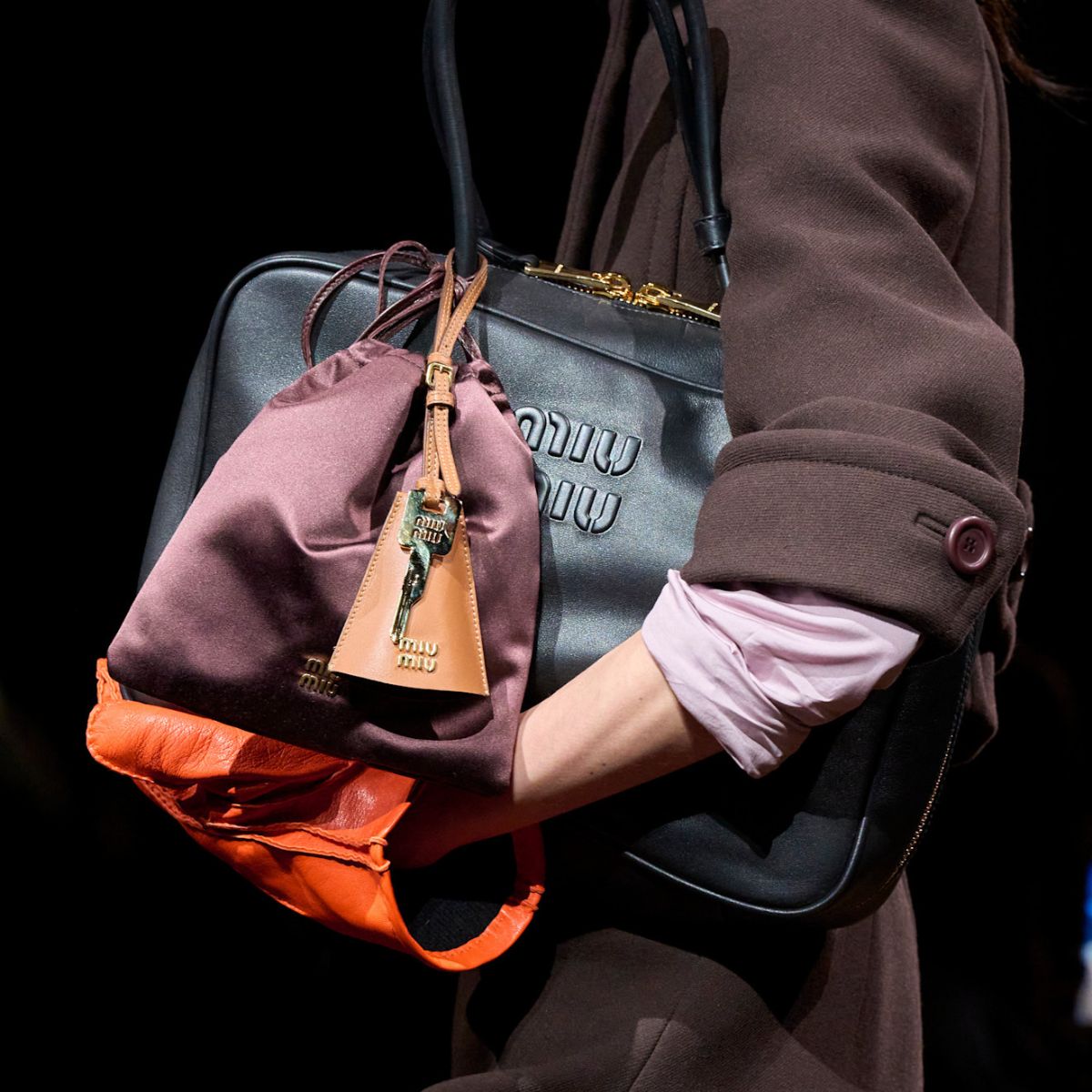 An image of the doctor's bag trend on the Miu Miu runway.