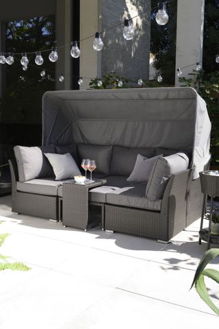 sofa will pull down canopy for added shade on a patio space