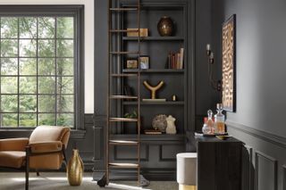 a dark painted home office with open shelving
