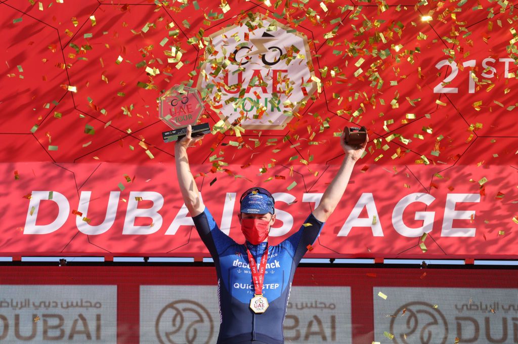 Sam Bennett of Deceuninck Quick Step celebrates on the podium after winning the sixth stage of the UAE Cycling Tour From Dubai Deira Islands to Dubai Palm Jumeriah on February 26 2021 Photo by Giuseppe CACACE AFP Photo by GIUSEPPE CACACEAFP via Getty Images
