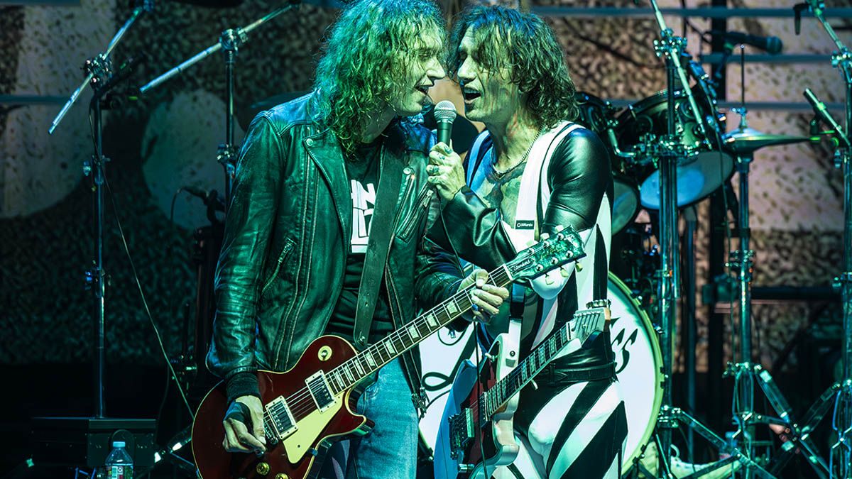 The Darkness&#039; Dan (left) and Justin Hawkins perform onstage in San Francisco in 2023