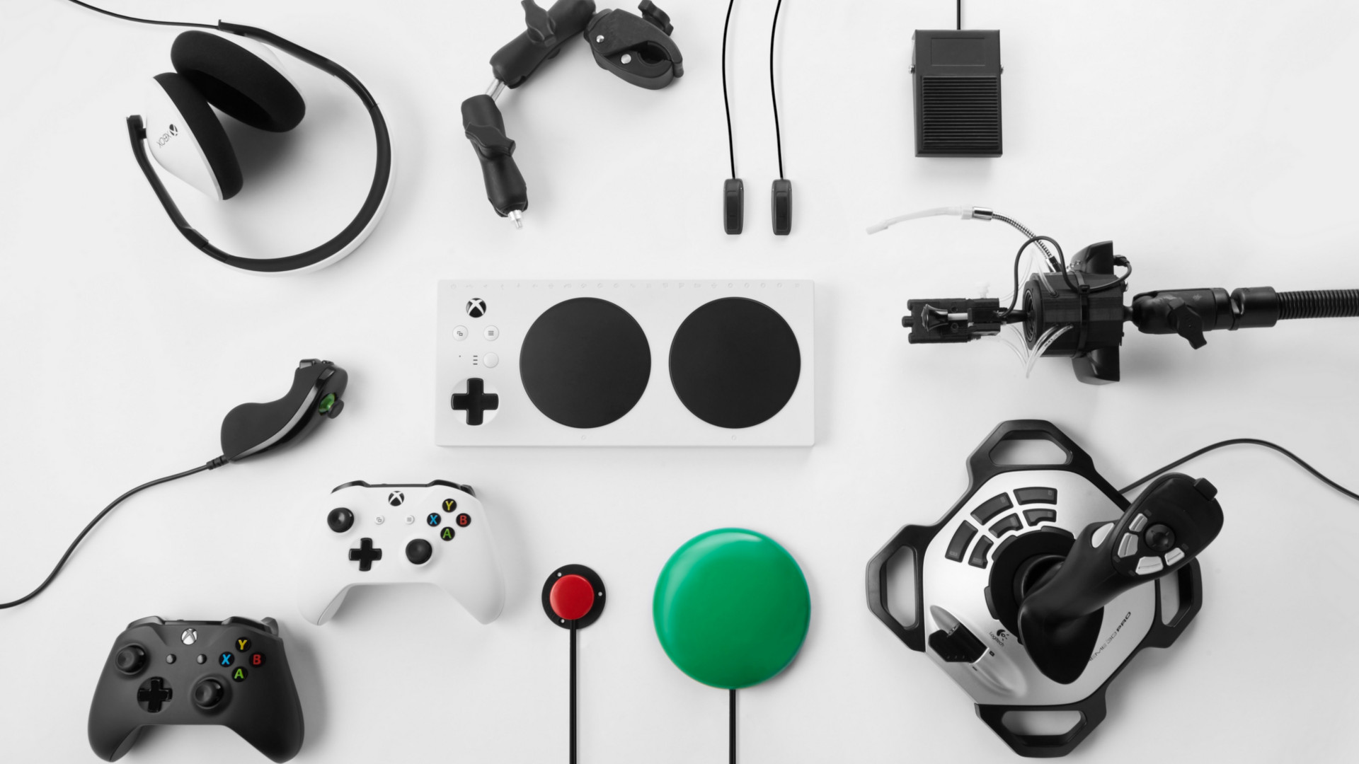 Microsoft adaptive controller surrounded by Microsoft peripherals