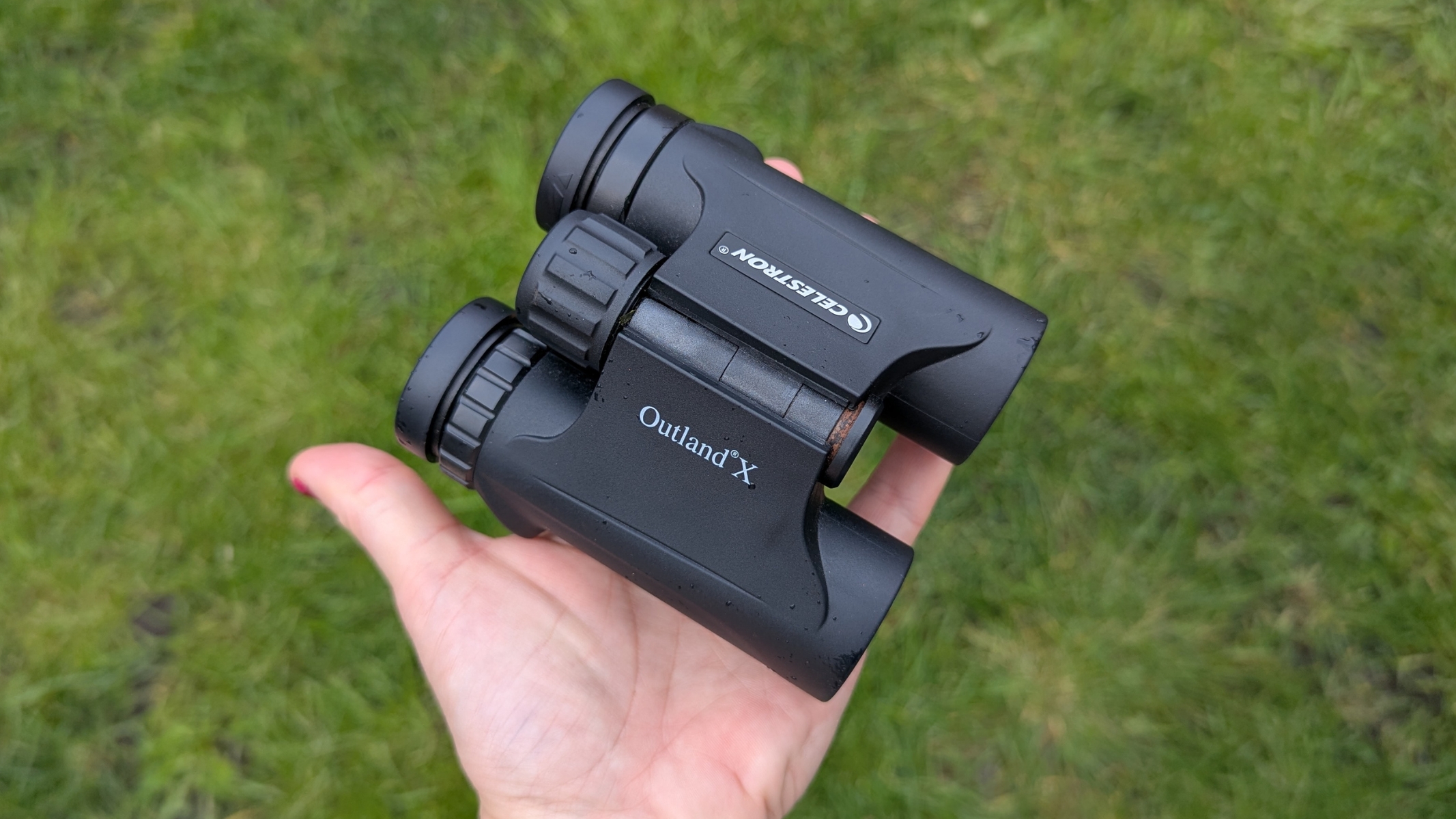 Celestron Outland X 10x25 in the hands of the reviewer during the hands-on review