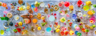 A colorful flat lay of cocktails, Bounty bars and dried fruit