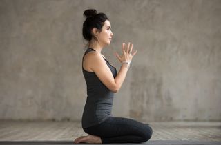 A woman doing a yoga pose to relax