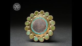 Many ornate artifacts in various stages of completion were found in the tomb, including this ear ornament made with gold and inlaid with semiprecious stones.