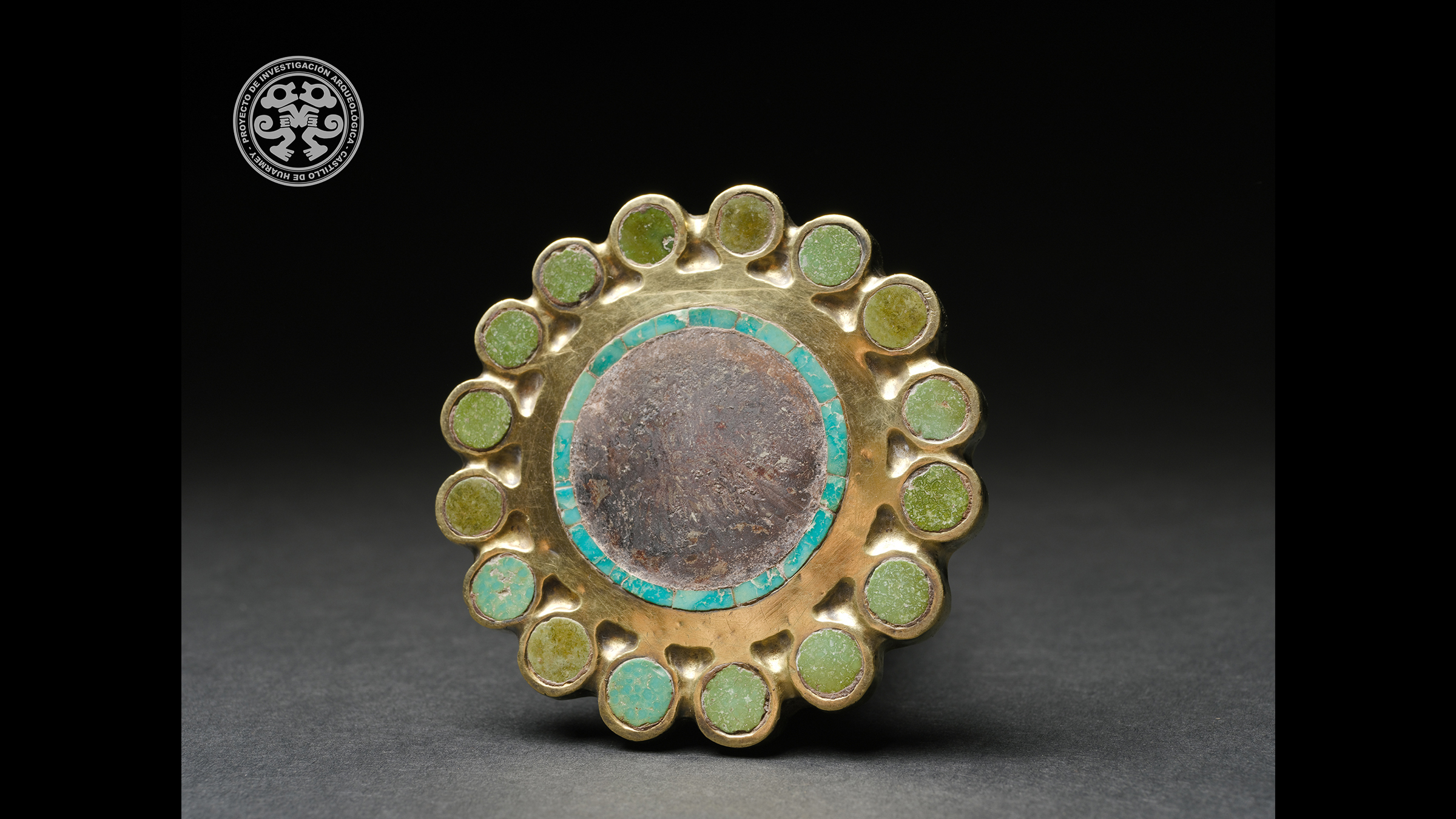 Many decorated artifacts in various stages of completion were found in the tomb, including this ear ornament made of gold and inlaid with semi-precious stones.