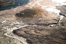 A stream flows through the toe of Kaskawulsh Glacier in Kluane National Park, Yukon. In 2016, this channel allowed the glacier's meltwater to drain in a different direction than normal, resulting in the Slims River water being rerouted to a different rive