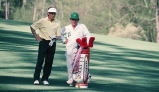 Bernhard Langer talks to his caddie whilst standing in the fairway during the 1993 Masters