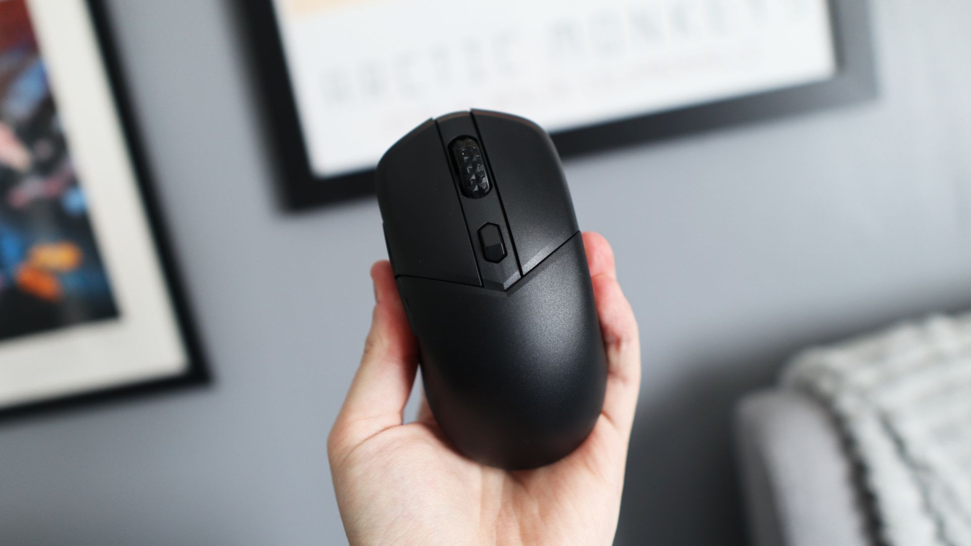 MSI Versa 300 Wireless 8K on a desk and held in a hand.