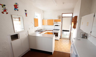 Olden styled kitchen with gas cooker and kitchen counter and cupboards