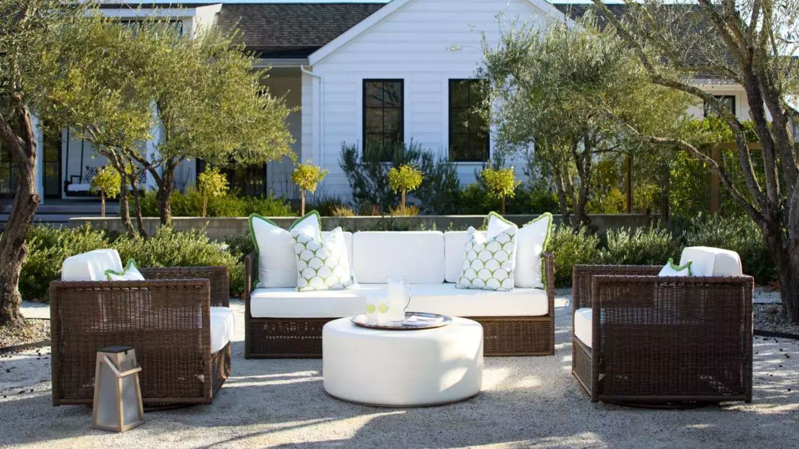 hamptons style outdoor patio area styled by serena and lily with dark brown wicker furniture