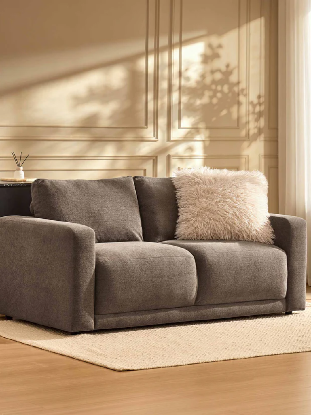 A two seater mushroom colored sofa from DUSK