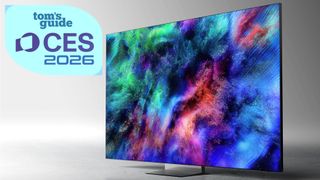 The Samsung R95H displaying colorful, abstract imagery against a neutral-toned, monochromatic background. There is a badge on the top-left corner of the image that reads: "Tom's Guide CES 2026."