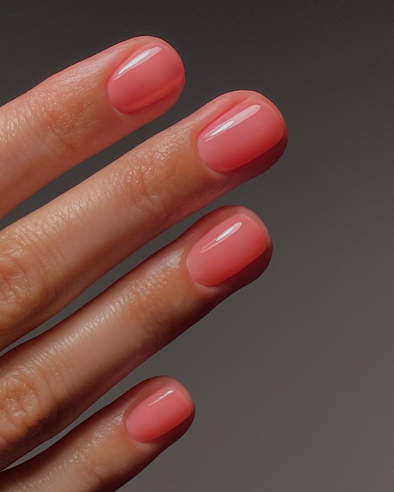 A close-up picture of a sheer pink, jelly inspired manicure