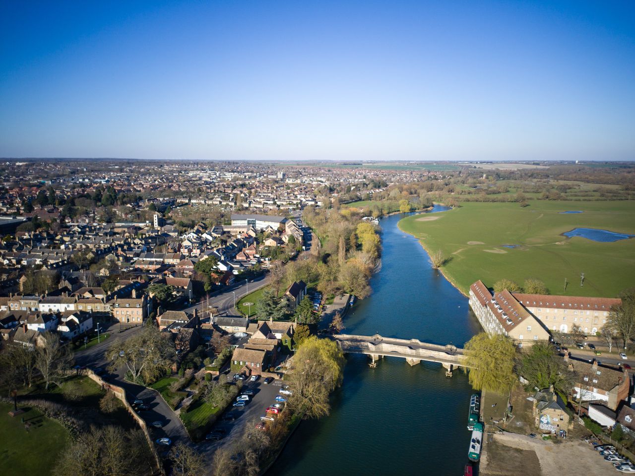 Photo of a river at the edge of a town taken with the Potensic Atom 2 drone