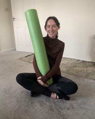 Katie trying at-home Reformer Pilates with a foam roller