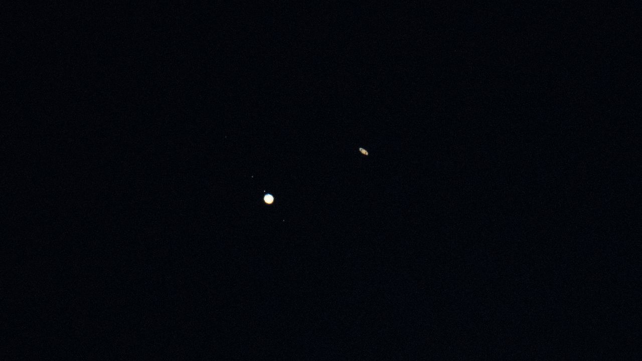 Jupiter (left) and Saturn (right) are seen after sunset above Jordan Lake during the "great conjunction" on Dec. 21, 2020, near Chapel Hill, North Carolina.