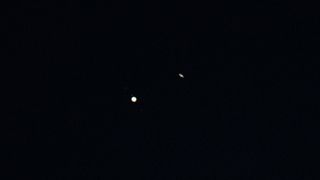 Jupiter (left) and Saturn (right) are seen after sunset above Jordan Lake during the "great conjunction" on Dec. 21, 2020, near Chapel Hill, North Carolina.
