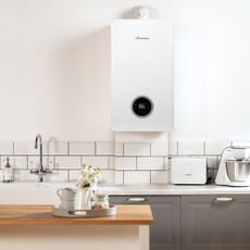 kitchen room with white boiler on white wall