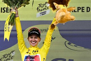 CanyonSRAM Racing teams Polish rider Katarzyna Niewiadoma celebrates on the podium wearing the overall leaders yellow jersey after winning the third edition of the Womens Tour de France cycling race and competing in the 8th and last stage of the Womens Tour de France cycling race a 1499 km between Le Grand Bornand and the Alpe dHuez in LAlpe dHuez southeastern France on August 18 2024 Photo by JULIEN DE ROSA AFP Photo by JULIEN DE ROSAAFP via Getty Images