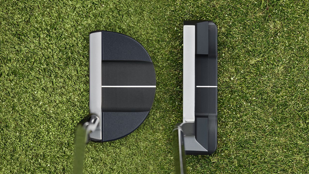 Looking down at two Bettinardi putters at address on a green