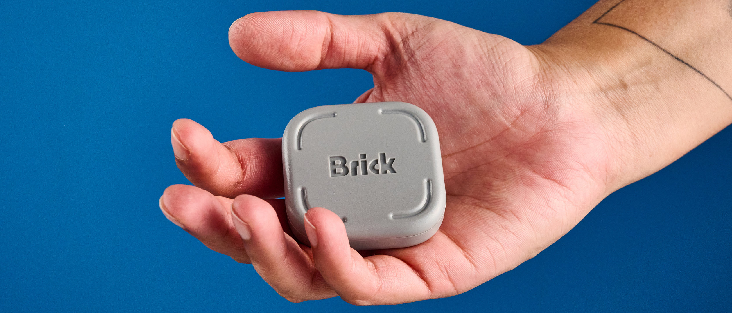 The Brick gadget photographed in front of a blue background
