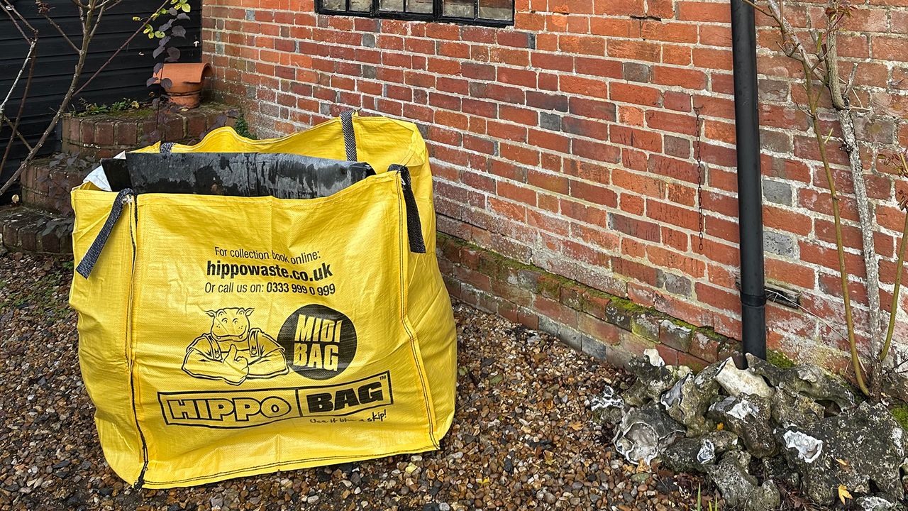 Yellow hippobag on gravel by a brick wall