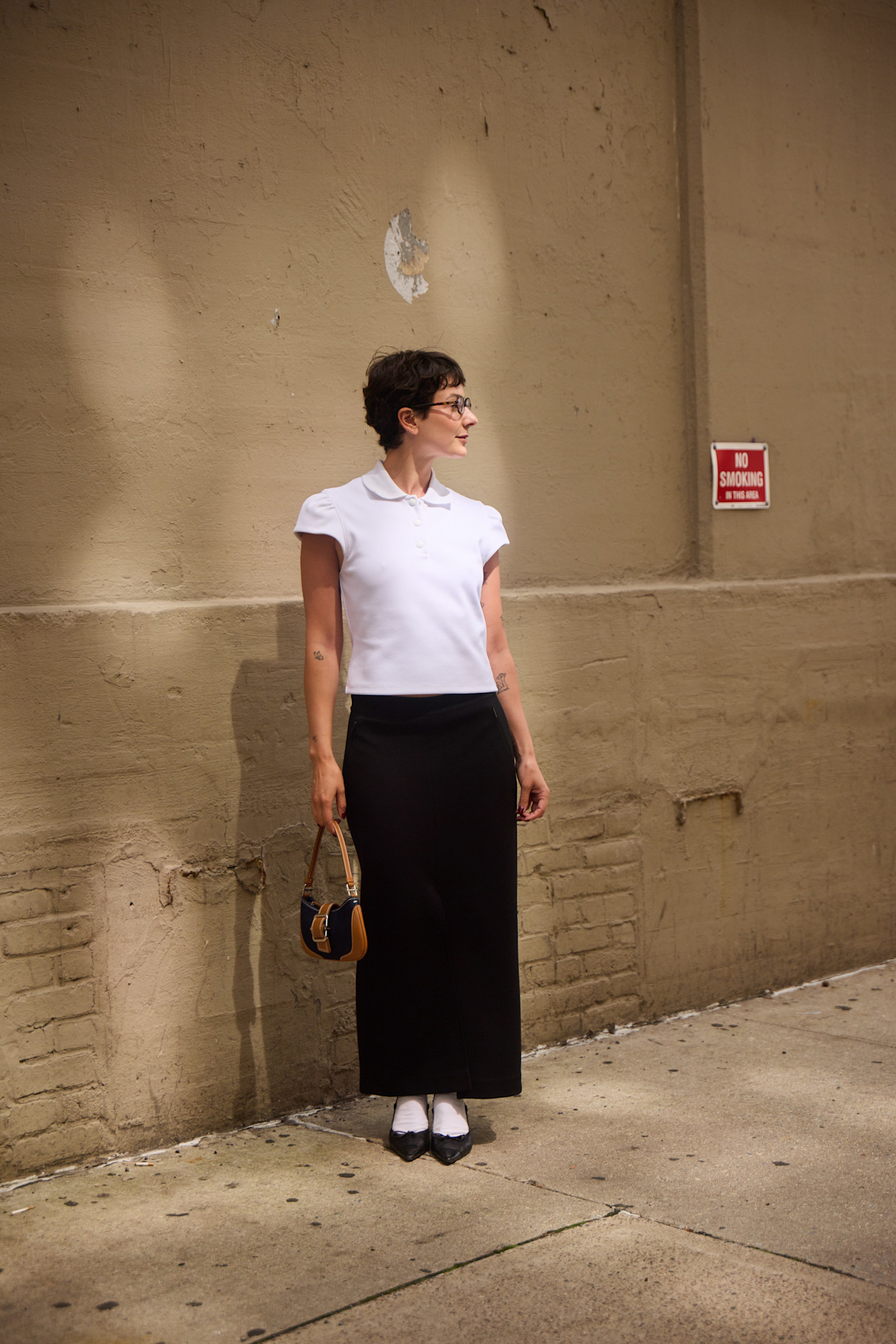 woman wearing polo shirt and maxi skrit and socks and kitten heelsf
