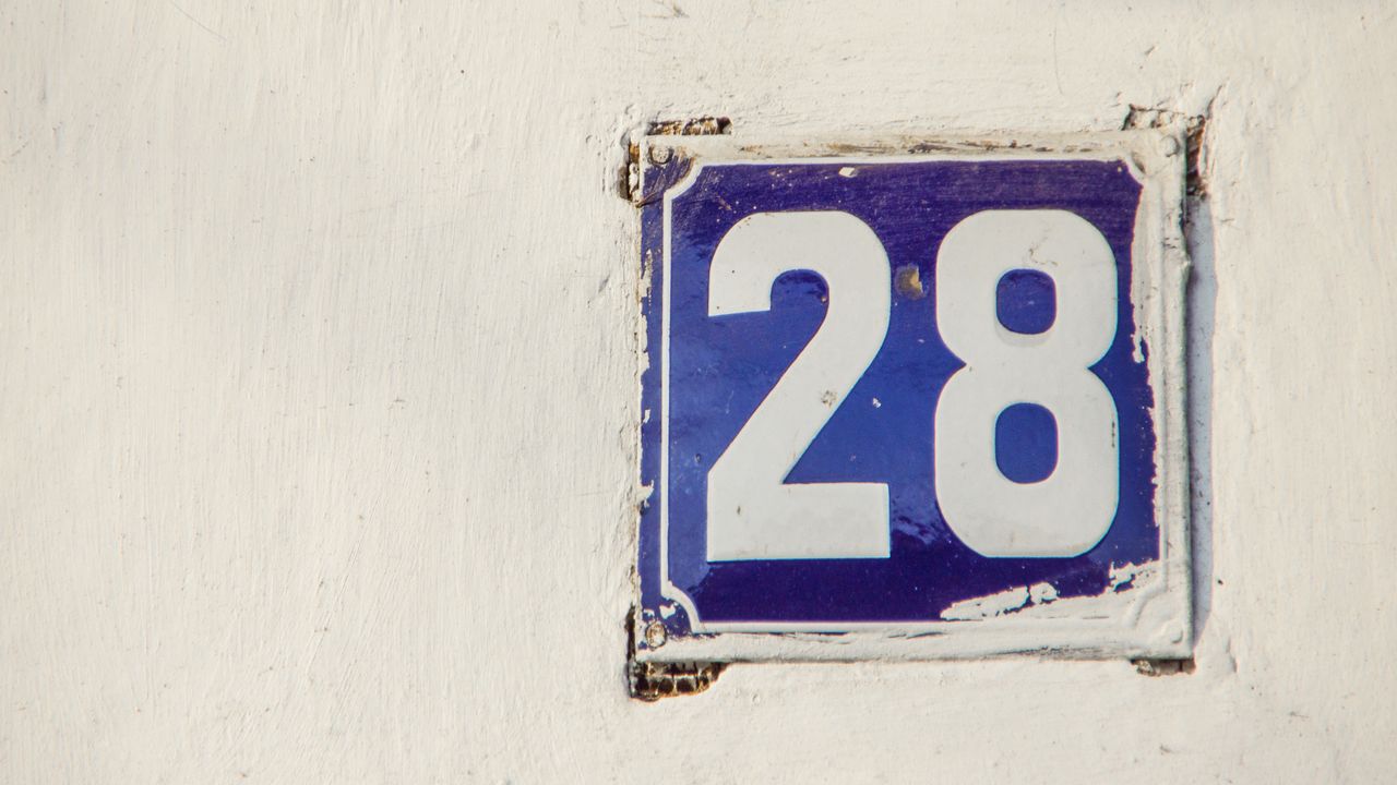 the number 28 on a brick wall