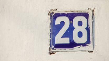 the number 28 on a brick wall