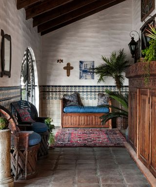 A spanish-style home's entry patio filled with antique furniture