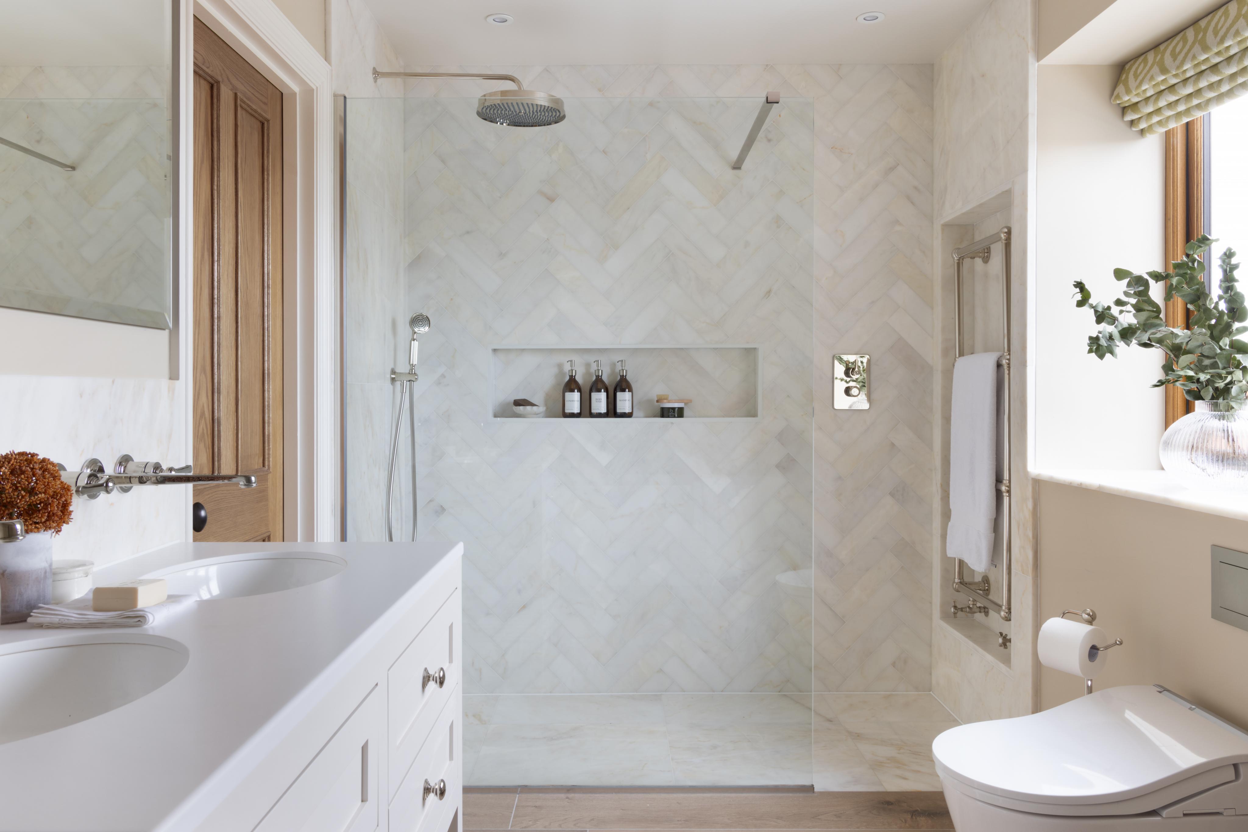 light, modern bathroom with a large walk in shower with cubby hole, recessed niche storage