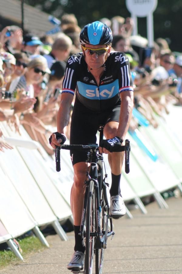 Bradley Wiggins crosses the line after a last kilometer mishap