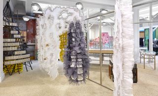 Installation at Dover street market, three sculpture like shapes wrapped in white lilac and white material
