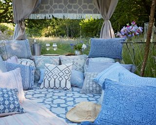 garden picnic with blue themed cushions and rug from weaver green