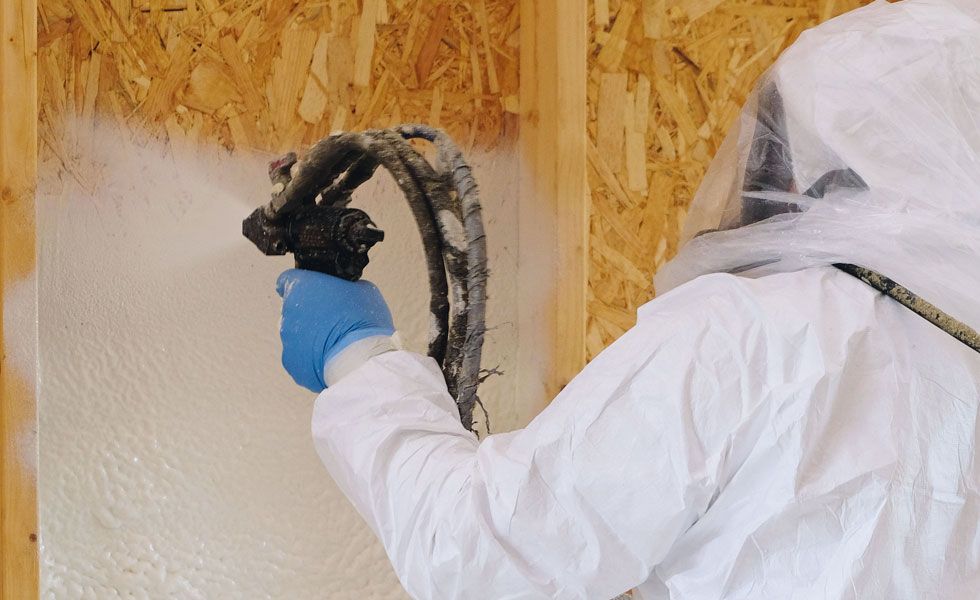 Man applying spray foam insulation