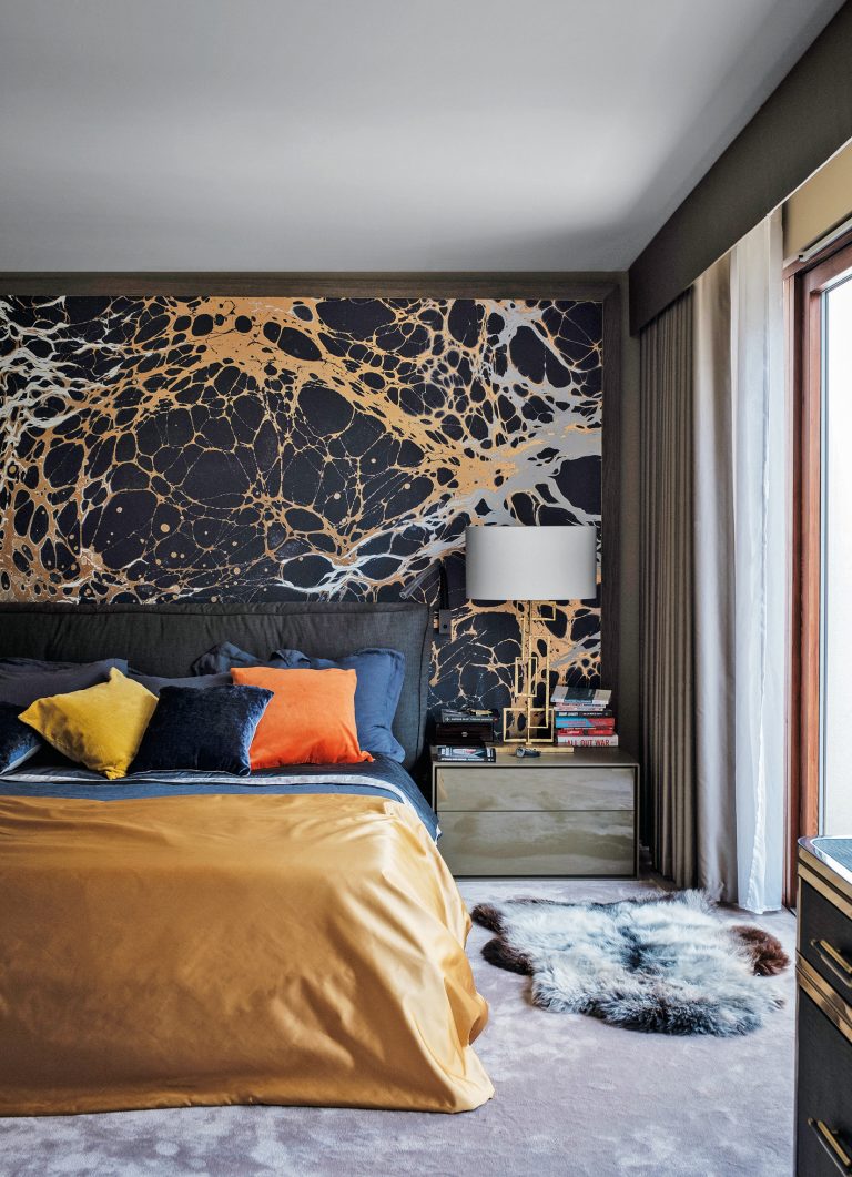 dark bedroom with yellow and black mural