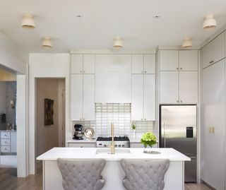 white compact kitchen with white countertops, metallic elements and retro lighting